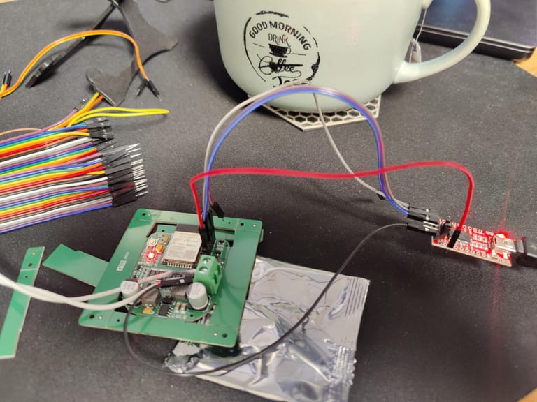 Flashing the ESP32 doorbell board over a USB-to-serial adapter on the desk.