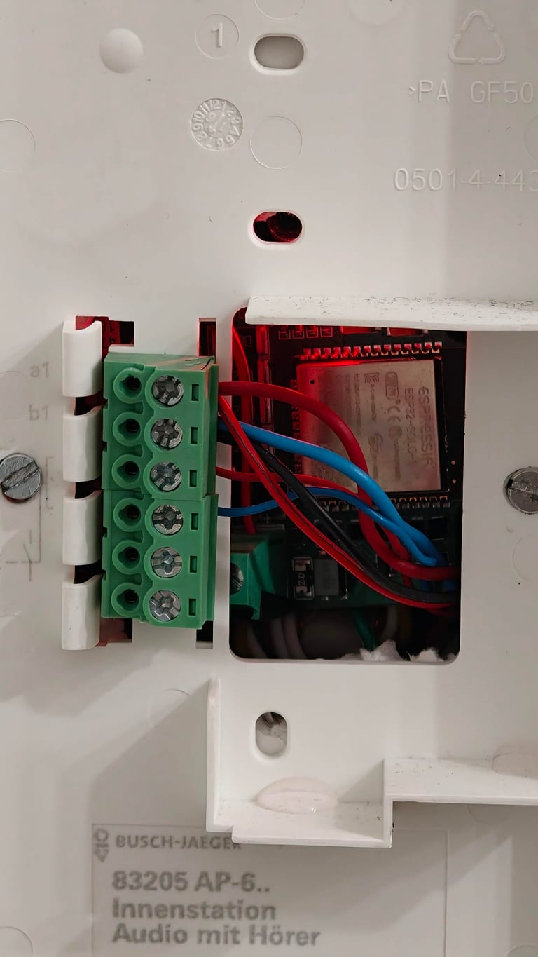 The ESP32 board wired into the a/b screw terminal inside the cable box behind the indoor station.